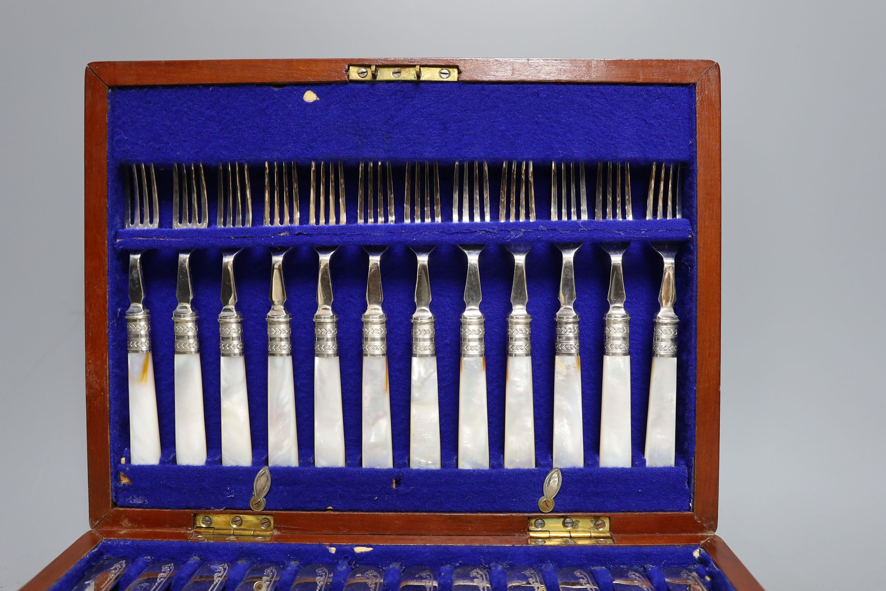 A cased set of silver handled pistol knives and a cased set of mother-of-pearl fruit knives and forks